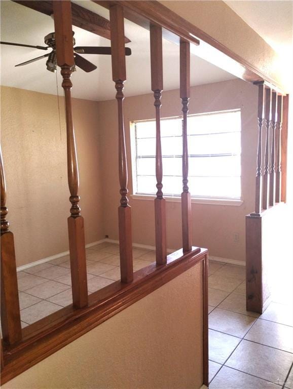 hall featuring light tile patterned flooring and a wealth of natural light