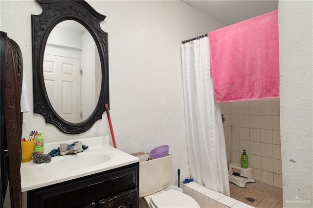 full bathroom featuring toilet, a stall shower, and vanity