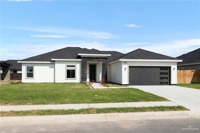 prairie-style house featuring a garage and a front yard