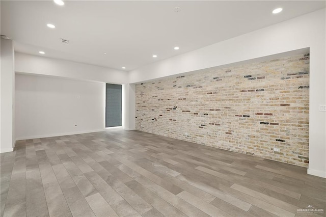 3804 S M St, Mcallen, TX 78503 - spare room featuring brick wall, recessed lighting, wood finished floors, and baseboards