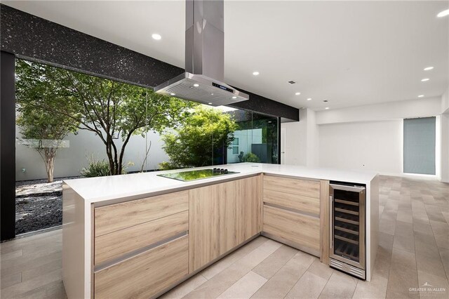 3804 S M St, Mcallen, TX 78503 - bar area with wine cooler, island exhaust hood, black electric cooktop, recessed lighting, and light tile patterned floors