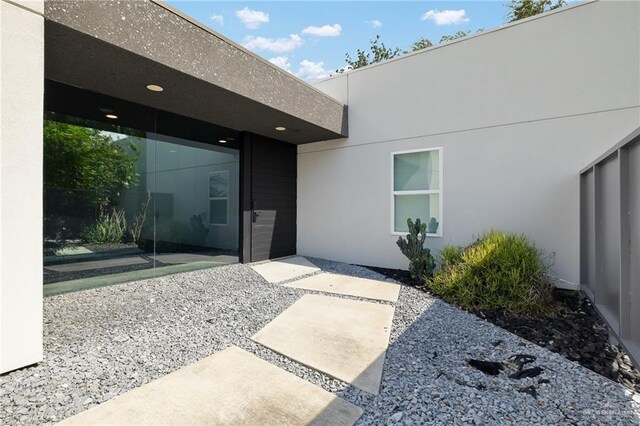 3804 S M St, Mcallen, TX 78503 - doorway to property with stucco siding and a patio area