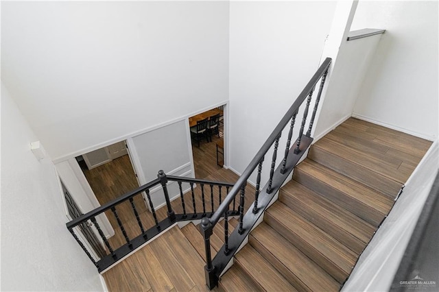 stairway with hardwood / wood-style floors