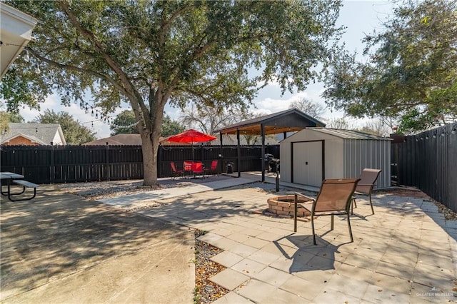 view of patio / terrace with a storage shed and an outdoor fire pit