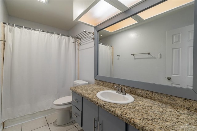 bathroom featuring vanity, toilet, and tile patterned flooring