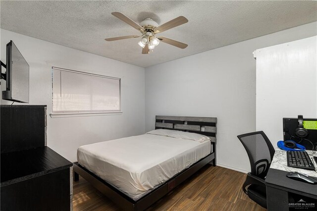 bedroom featuring dark hardwood / wood-style flooring, ceiling fan, and a textured ceiling