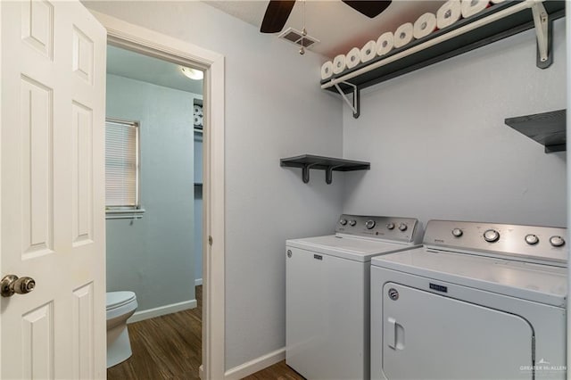 clothes washing area with ceiling fan, washing machine and clothes dryer, and dark hardwood / wood-style flooring