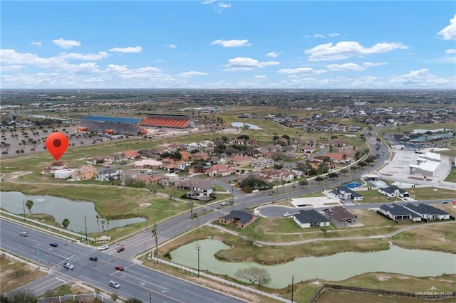 drone / aerial view featuring a water view and a residential view