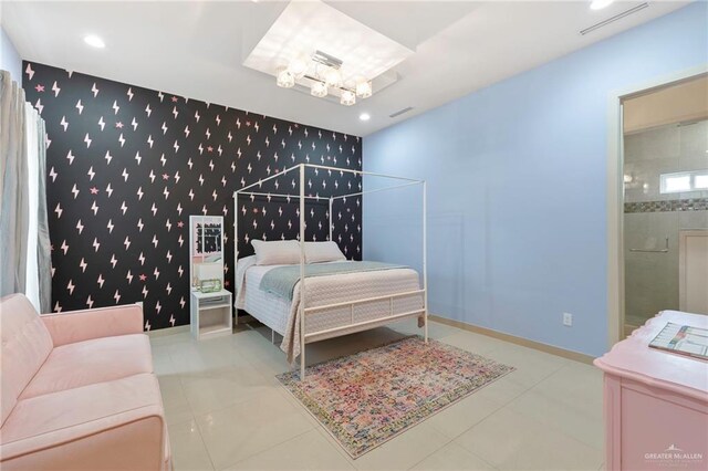 bedroom featuring wallpapered walls, baseboards, an accent wall, ensuite bathroom, and an inviting chandelier