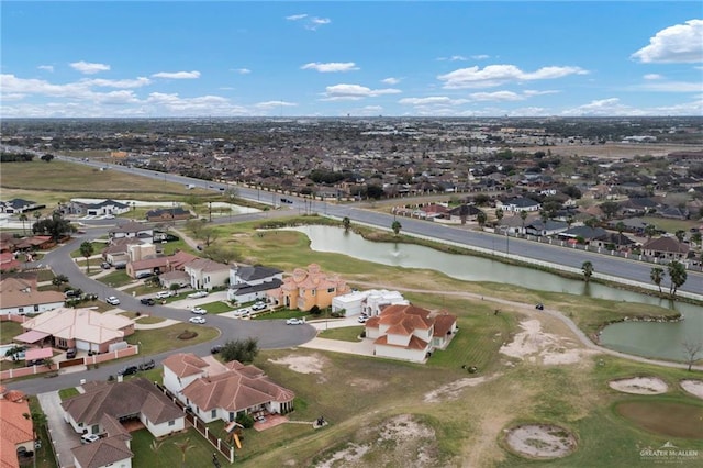 drone / aerial view featuring a residential view, a water view, and golf course view