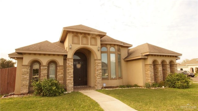 view of exterior entry featuring a yard