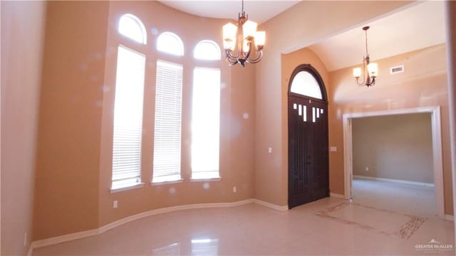 entrance foyer with tile patterned flooring and an inviting chandelier