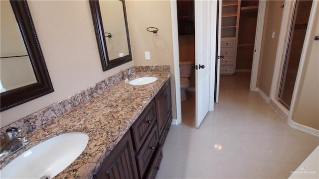 bathroom featuring an enclosed shower, vanity, and toilet