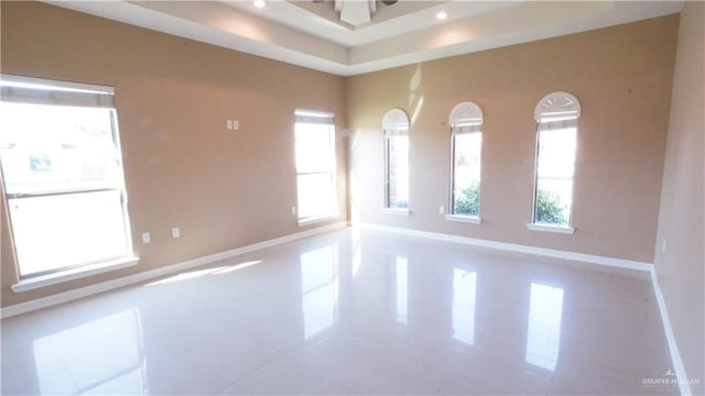 unfurnished room with ceiling fan and tile patterned flooring