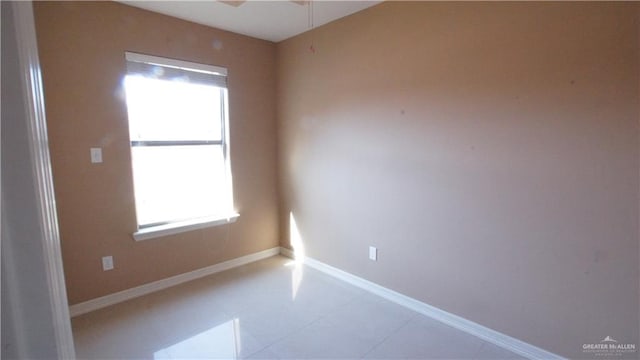 unfurnished room with tile patterned floors and plenty of natural light