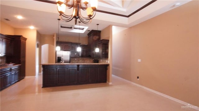 kitchen with dark brown cabinetry, kitchen peninsula, stainless steel fridge, a chandelier, and decorative backsplash