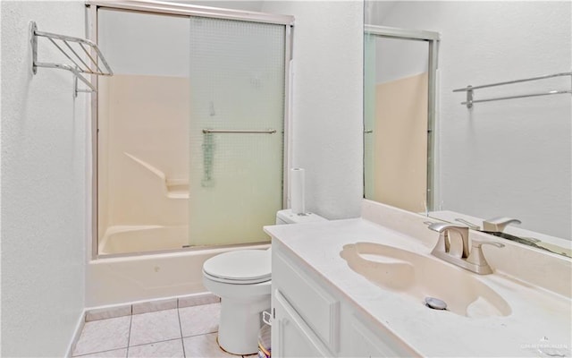 full bathroom with tile patterned flooring, vanity, enclosed tub / shower combo, and toilet