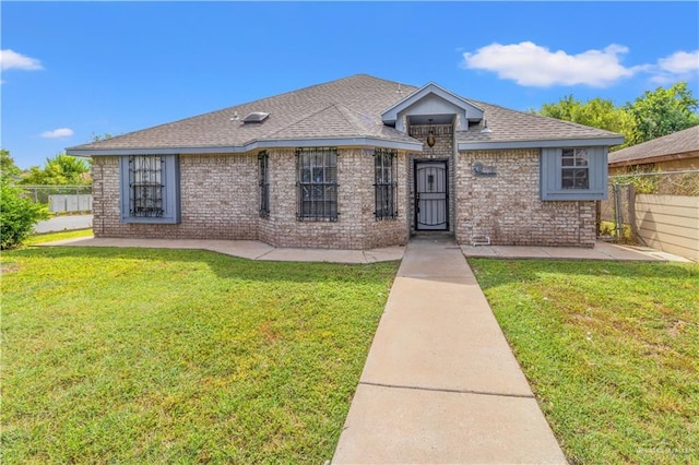 ranch-style home with a front lawn