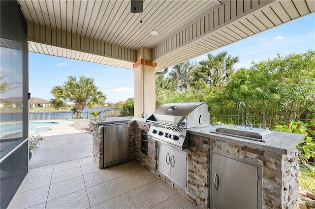 view of patio / terrace featuring an outdoor kitchen, a fenced in pool, and a grill