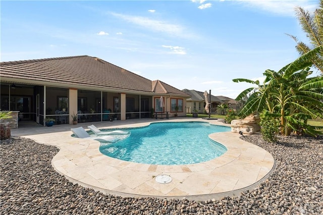 view of pool featuring a sunroom, a patio area, and a hot tub