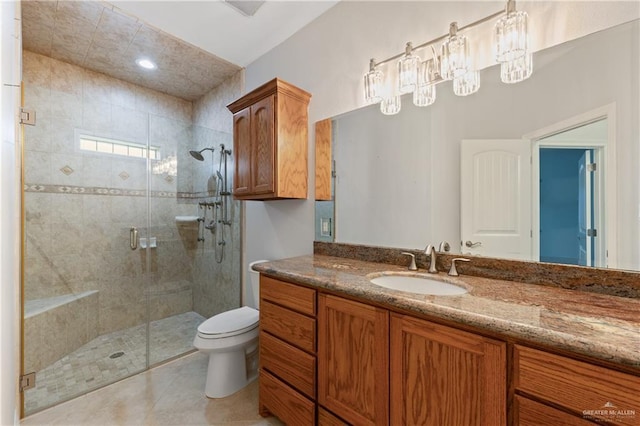 bathroom featuring toilet, vanity, and walk in shower