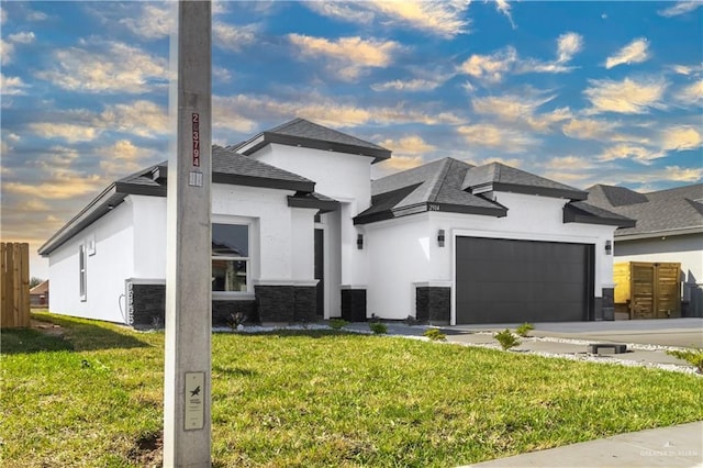 contemporary home with central AC, a garage, and a front lawn