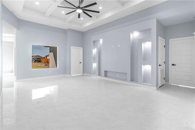 spare room with coffered ceiling, beamed ceiling, ceiling fan, and a high ceiling