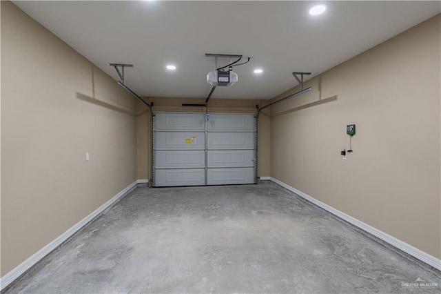 garage featuring a garage door opener and baseboards