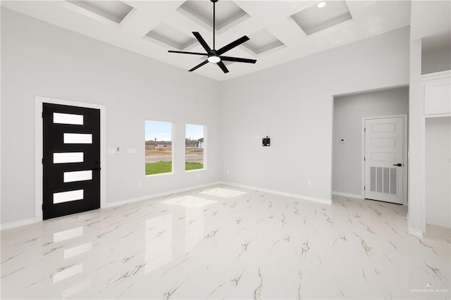 interior space with a high ceiling, coffered ceiling, ceiling fan, and beam ceiling