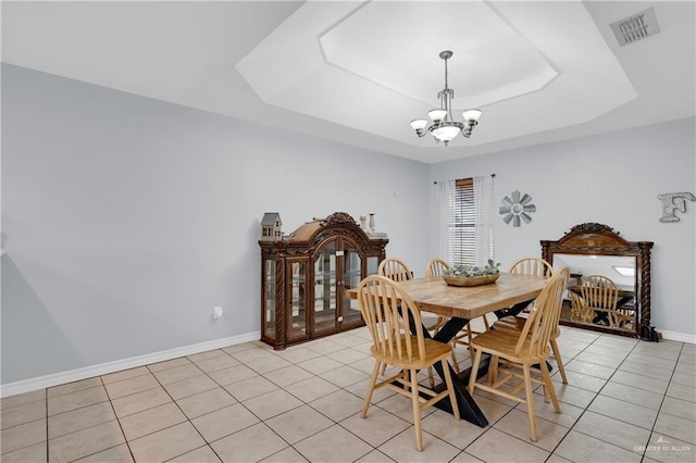 dining space with a chandelier, light tile patterned floors, visible vents, baseboards, and a raised ceiling