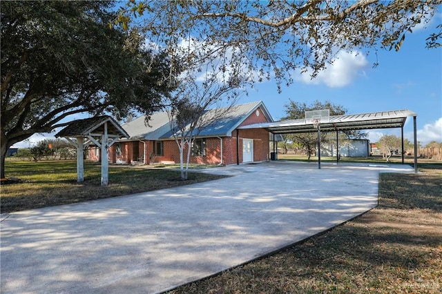 view of community featuring concrete driveway and a yard