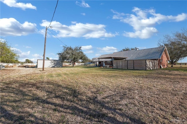 view of yard featuring an outbuilding and an outdoor structure