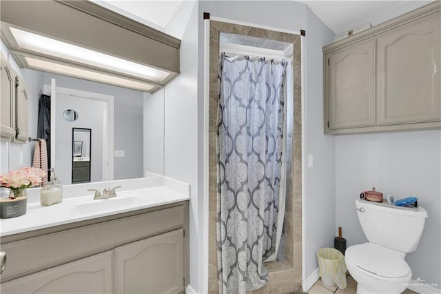 bathroom featuring toilet, a shower stall, and vanity