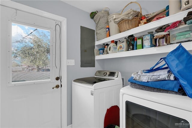 laundry room featuring laundry area, electric panel, and washer and clothes dryer