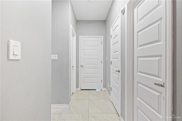 hallway featuring light tile patterned flooring