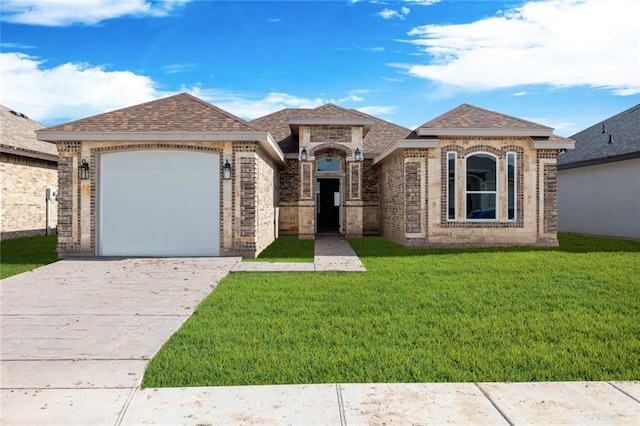 view of front of property with a garage and a front lawn