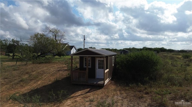 view of outdoor structure with a rural view