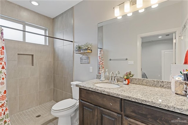 bathroom with toilet, vanity, and curtained shower