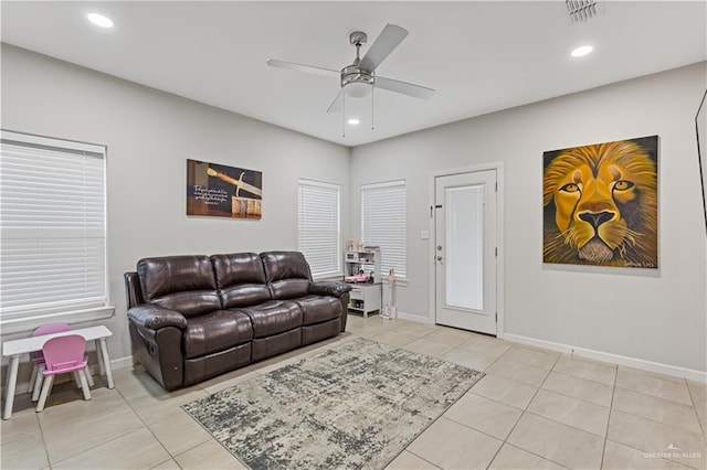 tiled living room featuring ceiling fan