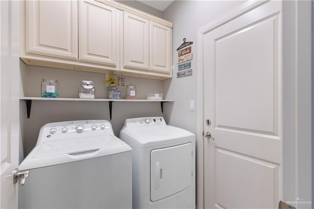 laundry room featuring cabinets and separate washer and dryer