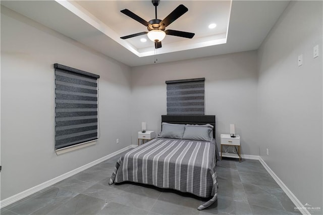 bedroom featuring ceiling fan and a tray ceiling