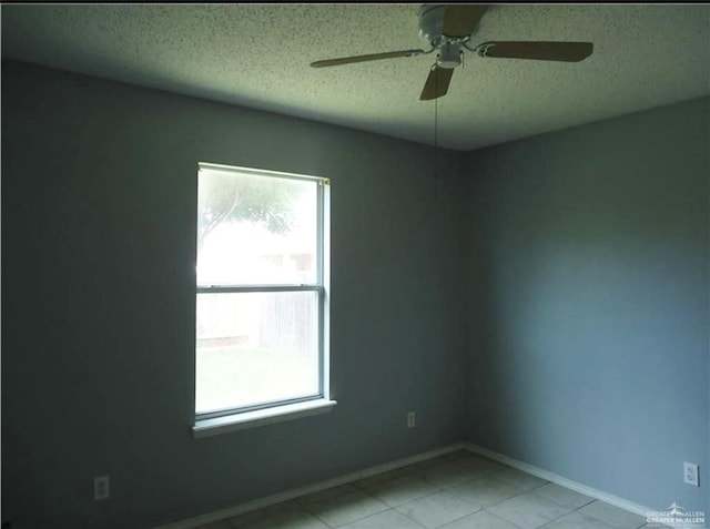 2246 Llano Grande Ln, Edinburg, TX 78542 - spare room featuring baseboards, a ceiling fan, a textured ceiling, and light tile patterned flooring