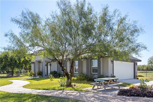 view of front of property featuring a garage and a front yard