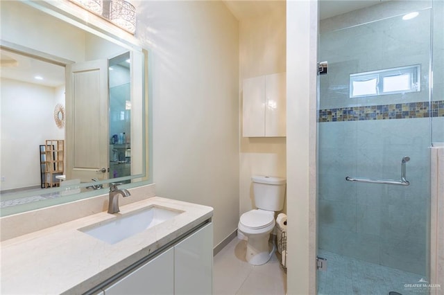 bathroom featuring tile patterned floors, a shower with door, vanity, and toilet