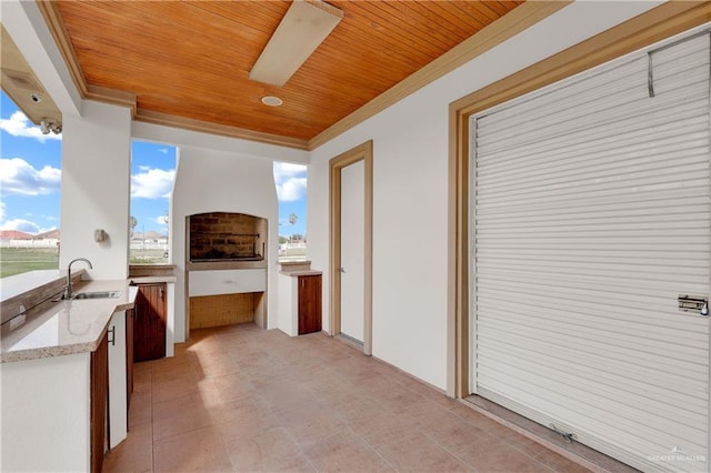 view of patio / terrace with ceiling fan and sink