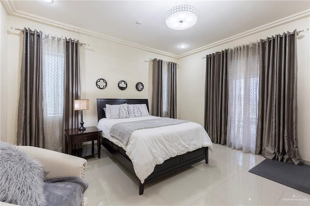 bedroom with light tile patterned floors and ornamental molding