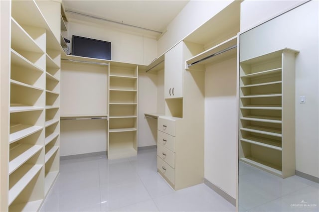 spacious closet featuring light tile patterned flooring