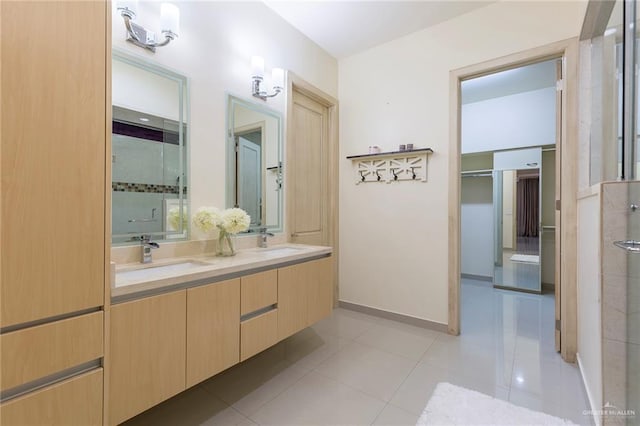 bathroom with tile patterned flooring, vanity, and walk in shower