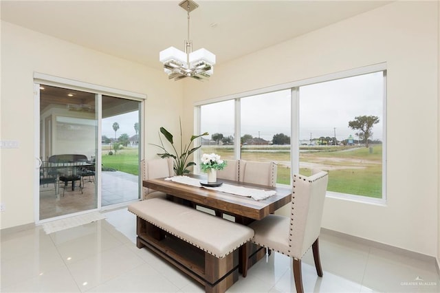 dining area featuring a chandelier and light tile patterned floors