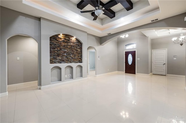 entrance foyer with light tile patterned floors, ceiling fan with notable chandelier, and a towering ceiling